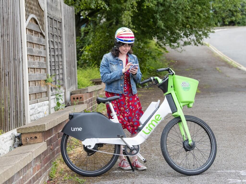 A woman using the app to hire an e-bike