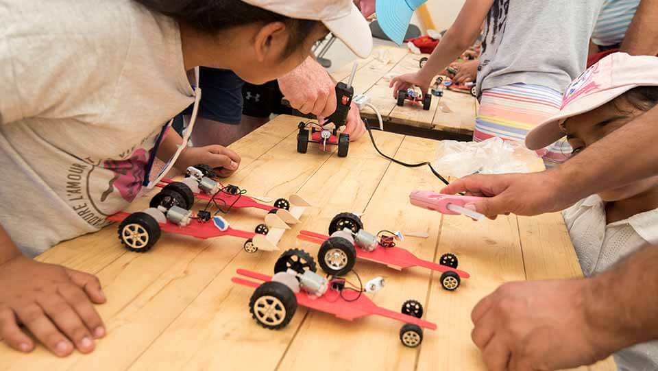 Children building electric cars