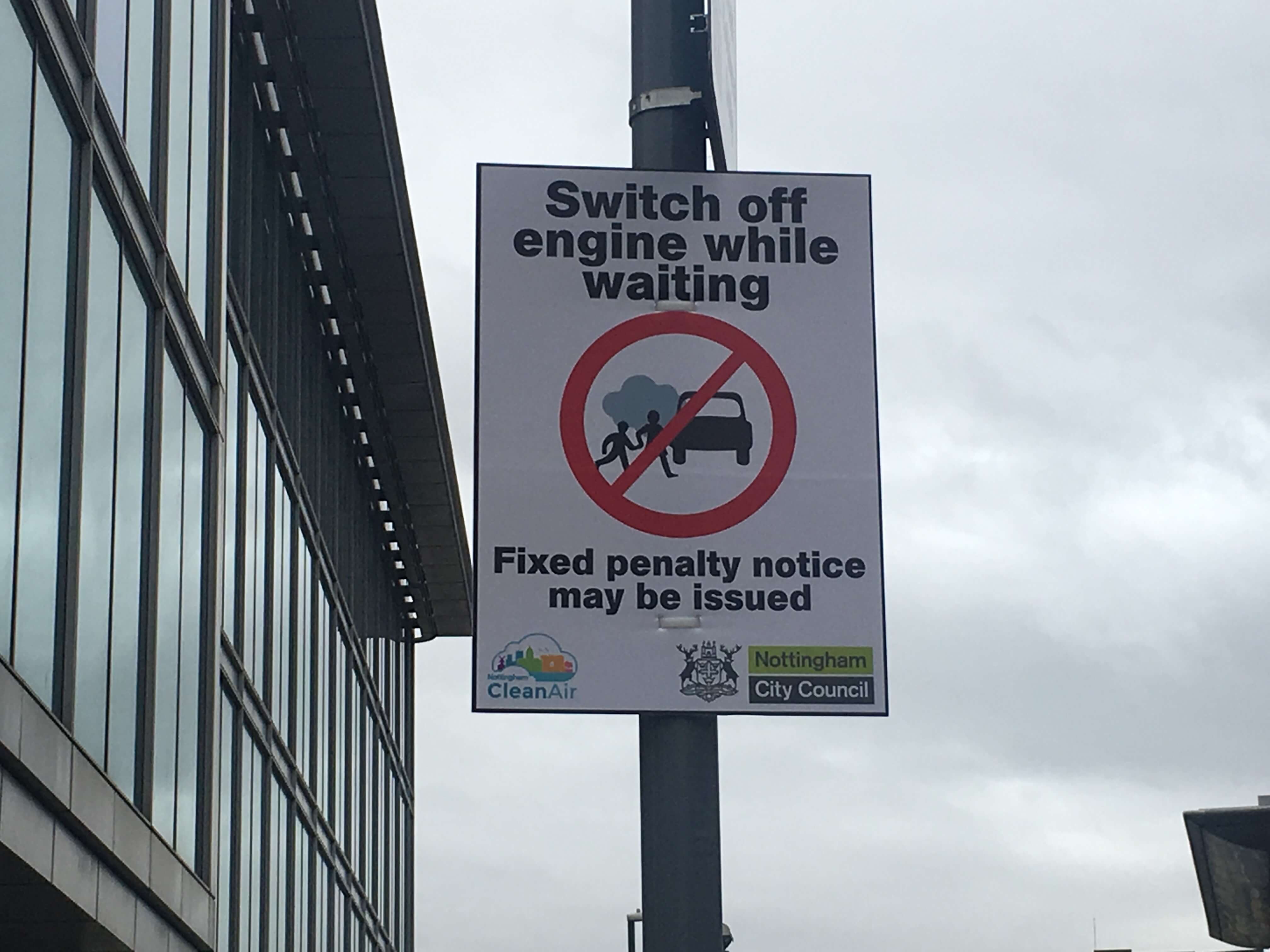 Road sign asking drivers to switch of engines while waiting