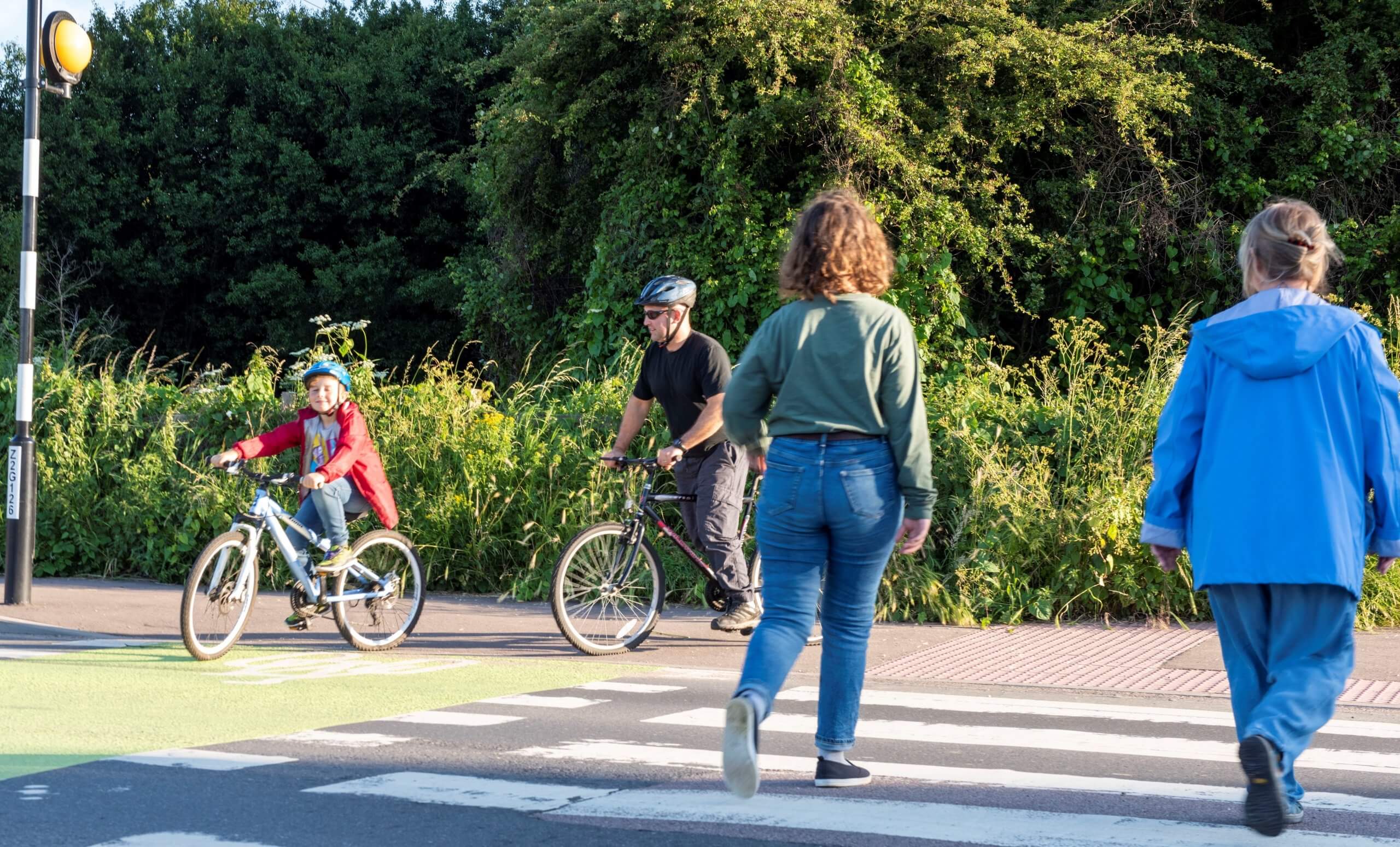 Pedestrians and cyclists crossing on a toucan crossing