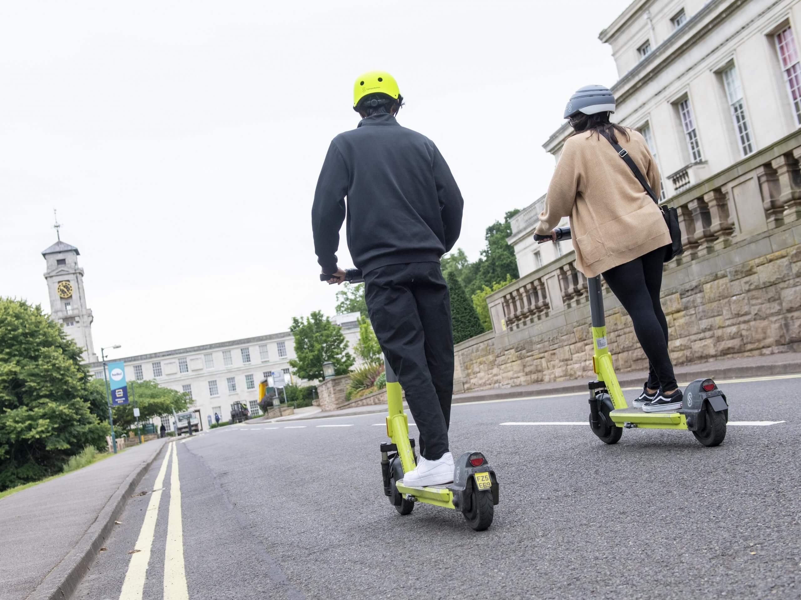 Two students on e-scooters on the University of Nottingham campus