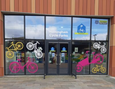 Broad Marsh Cycle Park window showing brightly coloured bike stickers