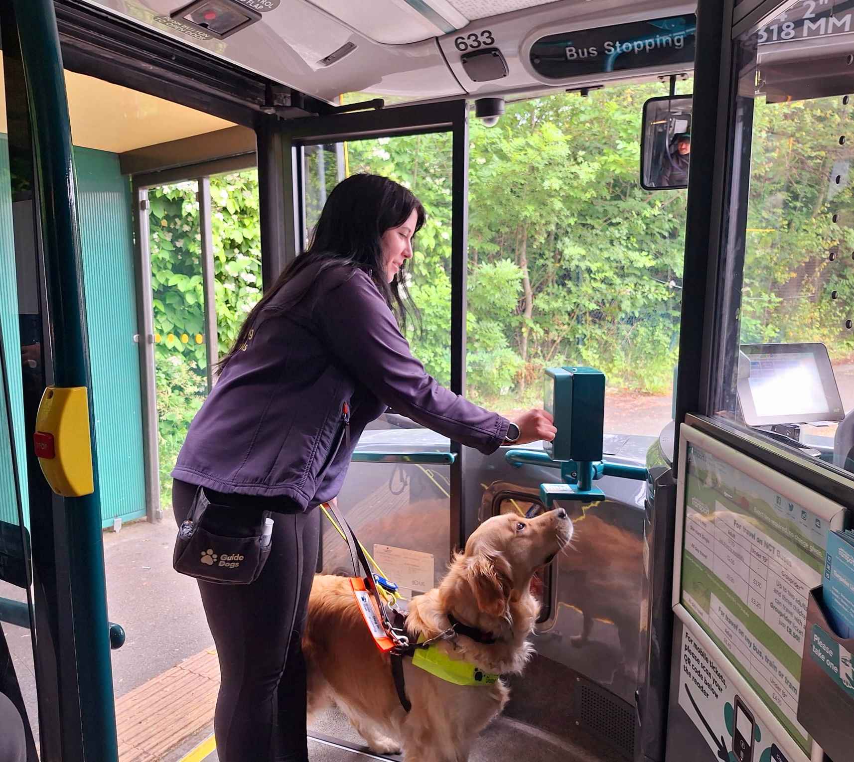 Trainer Faith showing guide dog Misty how to catch the bus